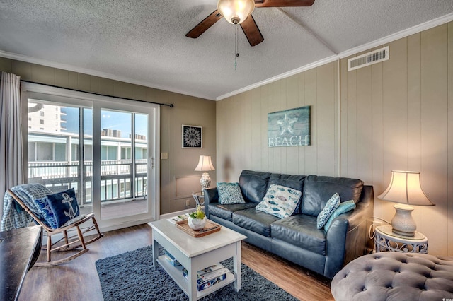 814 N Waccamaw Dr Unit 311, Garden City Beach, SC 29576 - living area with a ceiling fan, wood finished floors, a textured ceiling, and crown molding