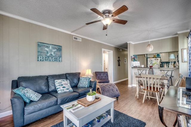 814 N Waccamaw Dr Unit 311, Garden City Beach, SC 29576 - living area with wood finished floors, ceiling fan, crown molding, and a textured ceiling