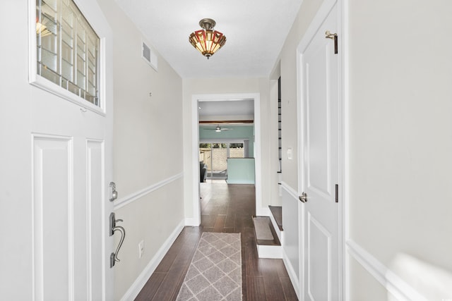 corridor with dark wood-type flooring and a textured ceiling