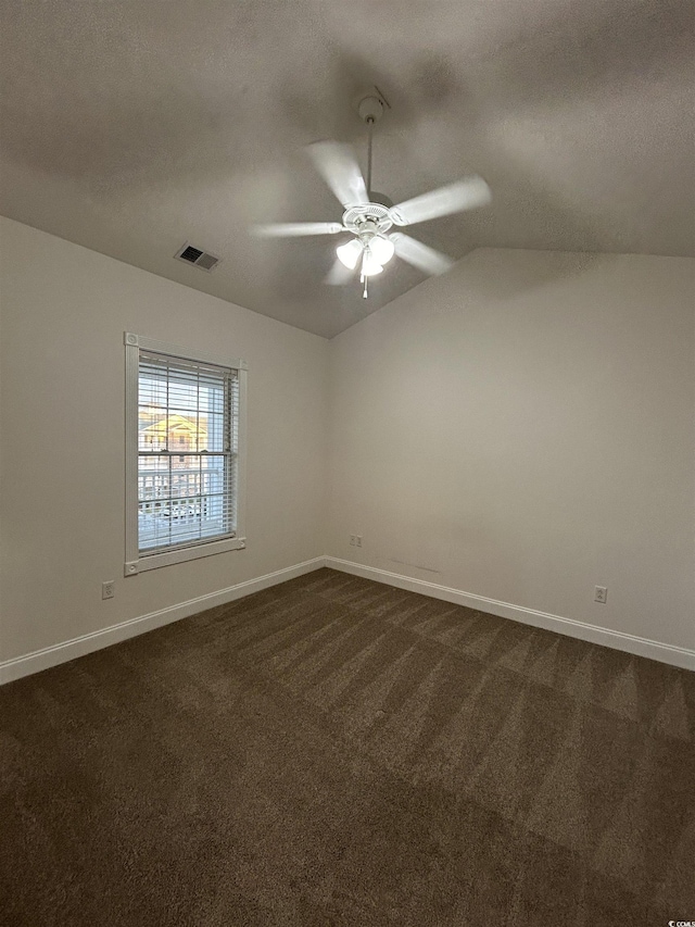 carpeted spare room with lofted ceiling, ceiling fan, and a textured ceiling