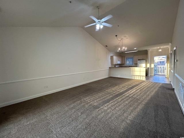 unfurnished living room with vaulted ceiling, ceiling fan with notable chandelier, and dark carpet