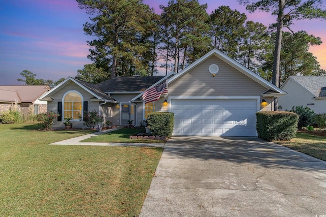 view of front facade with a yard and a garage