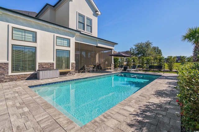 view of swimming pool with a patio area