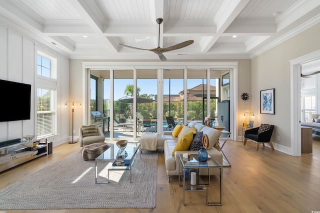 living room with beamed ceiling, ceiling fan, light hardwood / wood-style floors, and ornamental molding