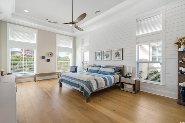 bedroom with light wood-type flooring, multiple windows, and ceiling fan