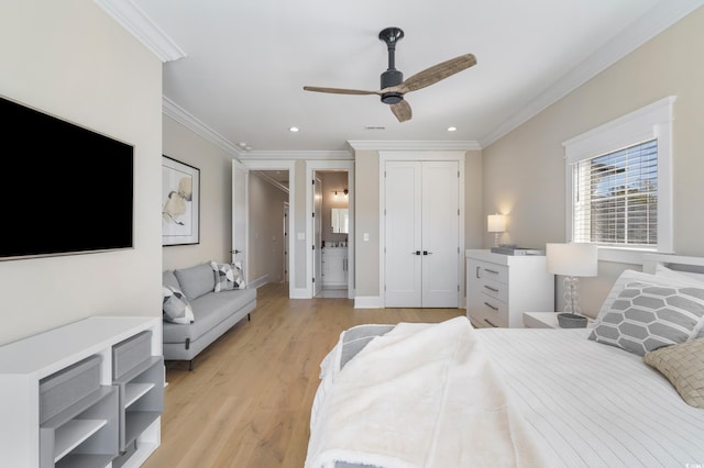 bedroom with light hardwood / wood-style floors, ensuite bath, ceiling fan, and ornamental molding