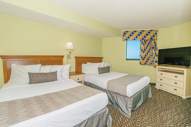 carpeted bedroom with a textured ceiling