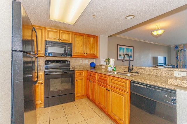 kitchen with kitchen peninsula, crown molding, sink, and black appliances