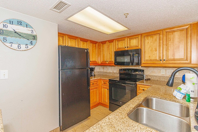 kitchen with black appliances, decorative backsplash, sink, and a textured ceiling