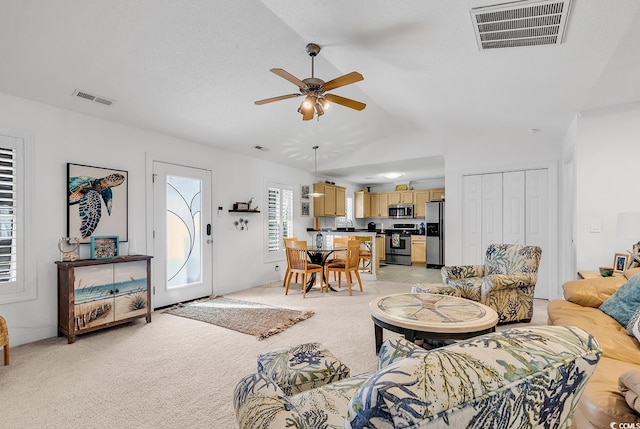 carpeted living room featuring ceiling fan