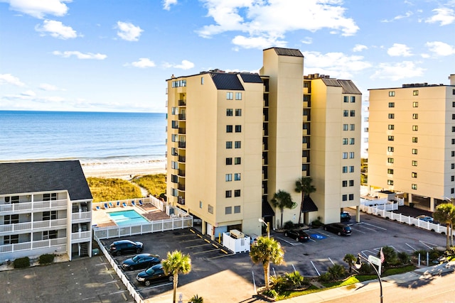 view of property featuring a water view and a beach view