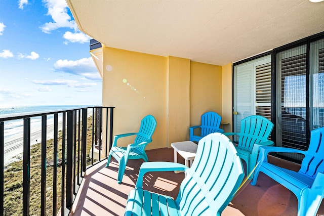 balcony with a beach view and a water view