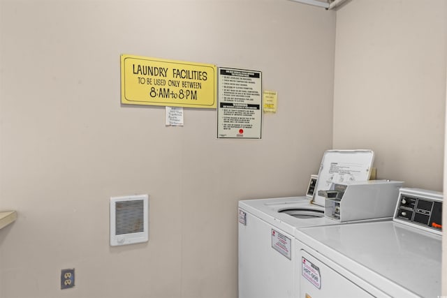 laundry room featuring washing machine and dryer and heating unit