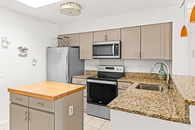 kitchen with light stone countertops, sink, stainless steel appliances, gray cabinets, and light tile patterned floors