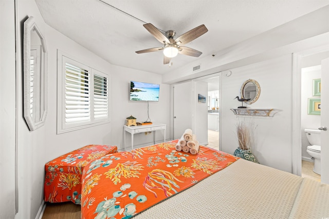 bedroom featuring ensuite bathroom and ceiling fan