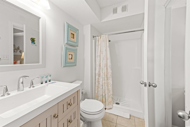 bathroom featuring tile patterned floors, vanity, curtained shower, and toilet