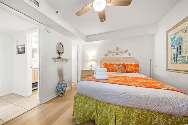 bedroom with ensuite bath, ceiling fan, and light wood-type flooring