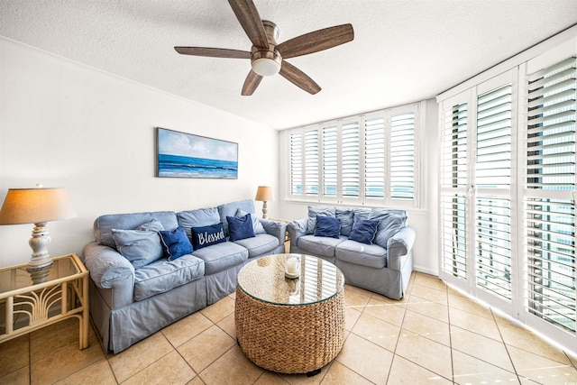 living room with light tile patterned floors, a textured ceiling, and ceiling fan