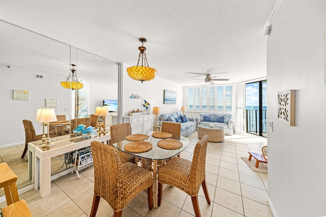 dining area featuring floor to ceiling windows, ceiling fan, light tile patterned flooring, and a textured ceiling