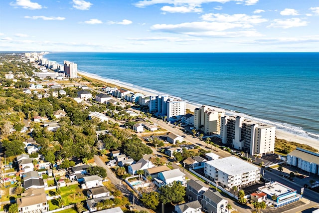 drone / aerial view featuring a beach view and a water view