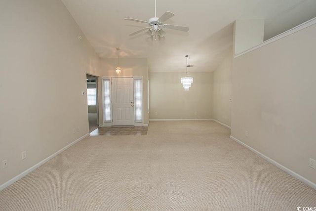 foyer with light carpet and ceiling fan with notable chandelier