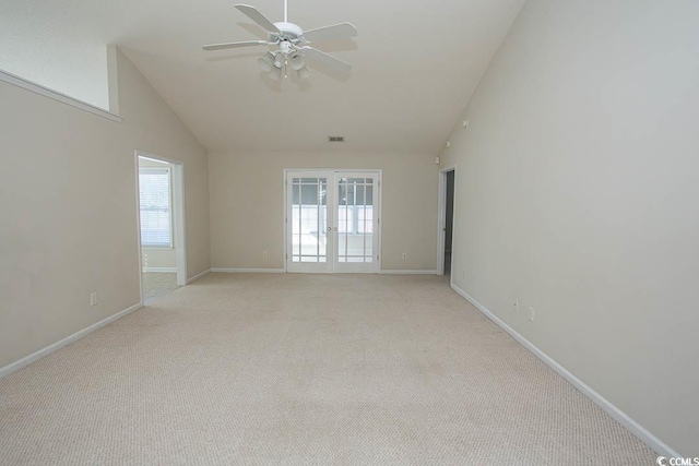 carpeted spare room with french doors, high vaulted ceiling, plenty of natural light, and ceiling fan