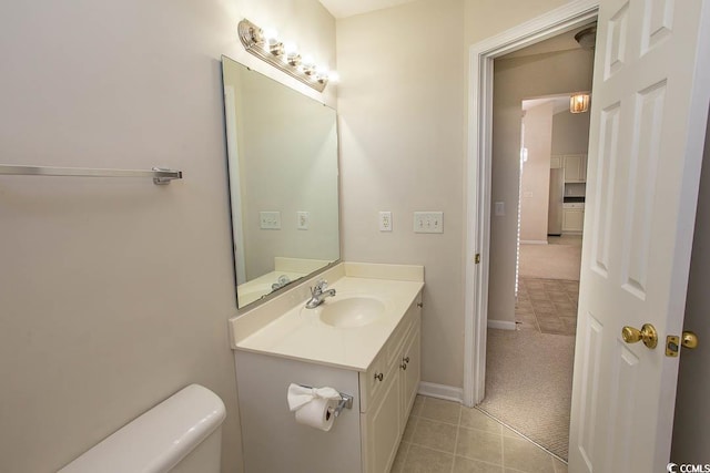 bathroom with tile patterned floors, vanity, and toilet