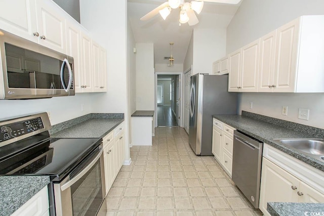 kitchen with ceiling fan, sink, white cabinets, and appliances with stainless steel finishes