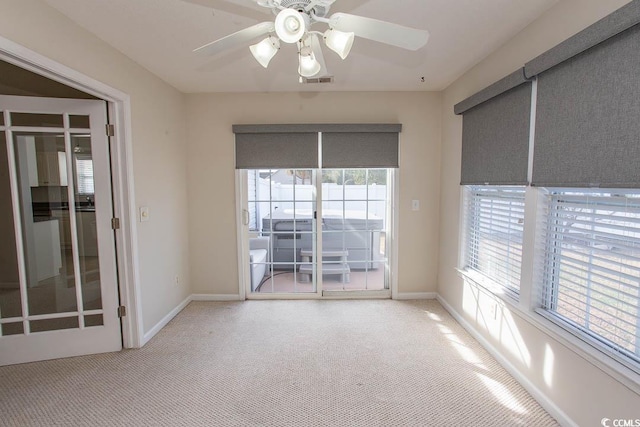 carpeted spare room with ceiling fan