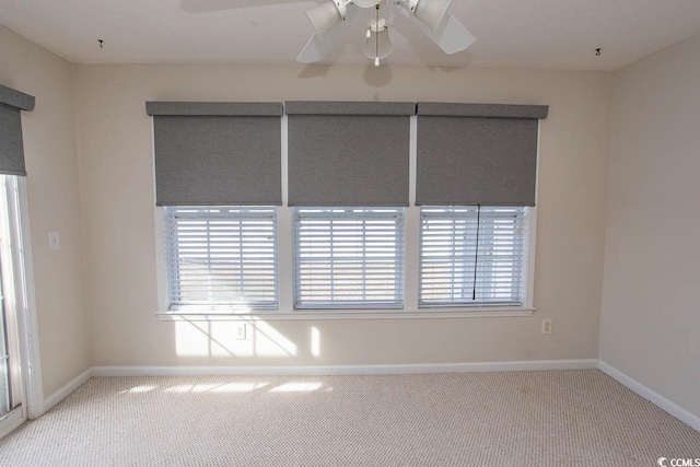 spare room with carpet flooring and ceiling fan