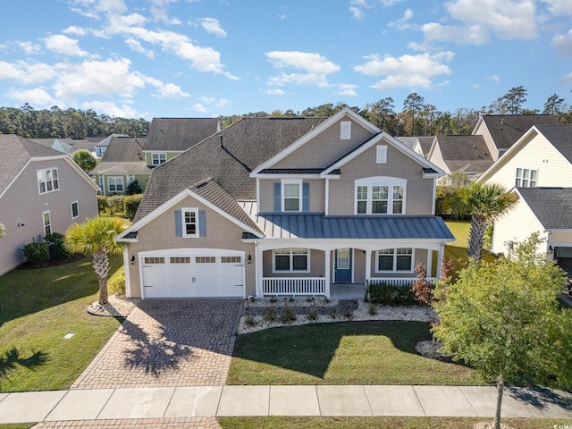 craftsman-style home with a porch and a front yard