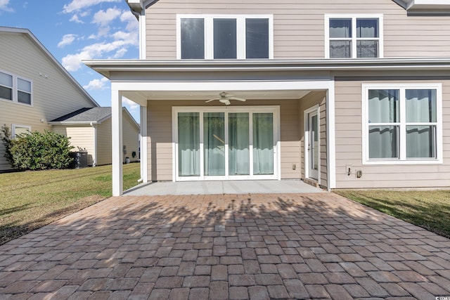 back of property with central AC, ceiling fan, a yard, and a patio