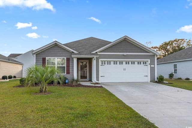 view of front of home with a garage and a front lawn