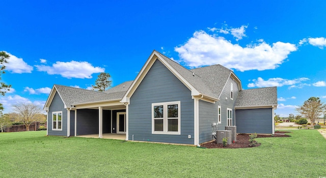 rear view of property with central AC, a yard, and a patio