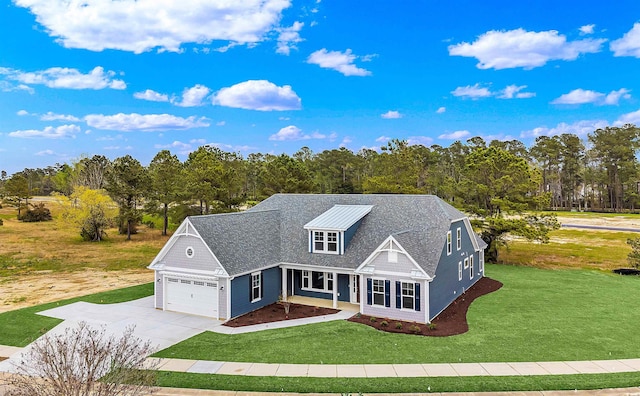 view of front of property featuring a garage and a front lawn