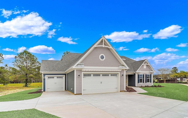 craftsman inspired home featuring a garage and a front lawn