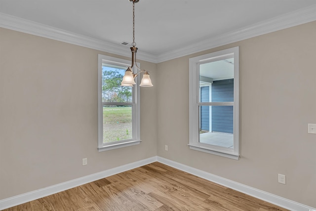 unfurnished room with light hardwood / wood-style flooring, a notable chandelier, and crown molding