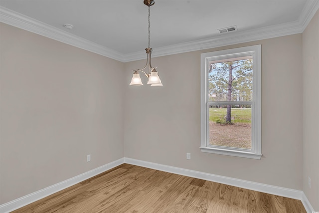 unfurnished room featuring a healthy amount of sunlight, light hardwood / wood-style floors, crown molding, and a chandelier