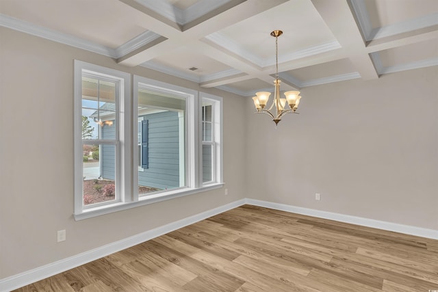 unfurnished room featuring coffered ceiling, crown molding, beam ceiling, an inviting chandelier, and light hardwood / wood-style floors