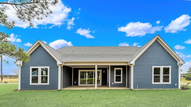 back of property featuring a lawn and a patio