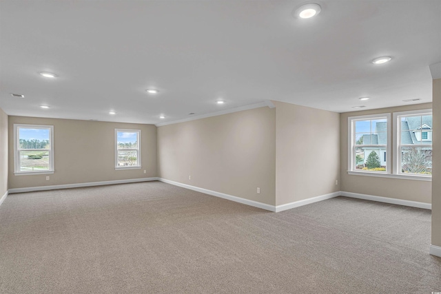 carpeted empty room featuring ornamental molding