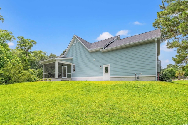 852 Comanders Island Rd, Georgetown, SC 29440 - back of property featuring a sunroom, a lawn, and roof with shingles