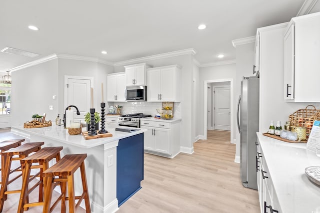 852 Comanders Island Rd, Georgetown, SC 29440 - kitchen featuring appliances with stainless steel finishes, a kitchen breakfast bar, white cabinets, recessed lighting, and backsplash