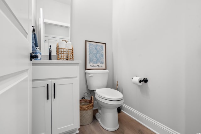 852 Comanders Island Rd, Georgetown, SC 29440 - half bathroom featuring wood finished floors, baseboards, toilet, and vanity