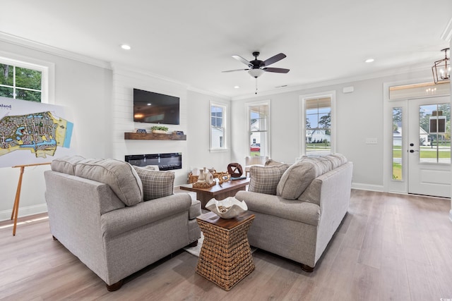 852 Comanders Island Rd, Georgetown, SC 29440 - living area featuring healthy amount of natural light, crown molding, light wood finished floors, recessed lighting, and a glass covered fireplace