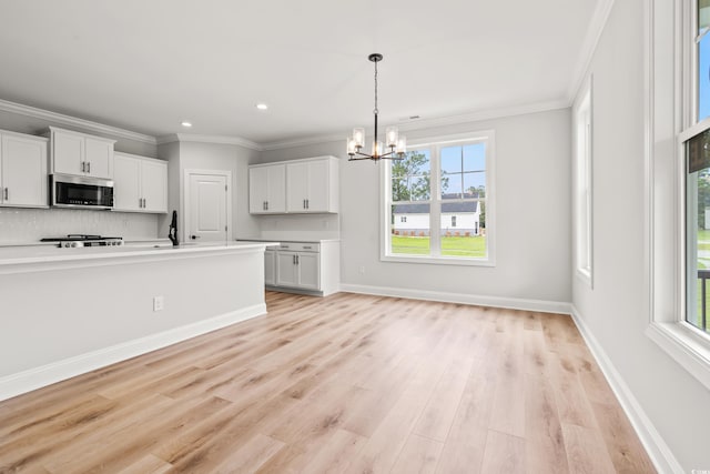805 Comanders Island Rd, Georgetown, SC 29440 - kitchen featuring stainless steel microwave, a chandelier, healthy amount of natural light, white cabinets, and recessed lighting