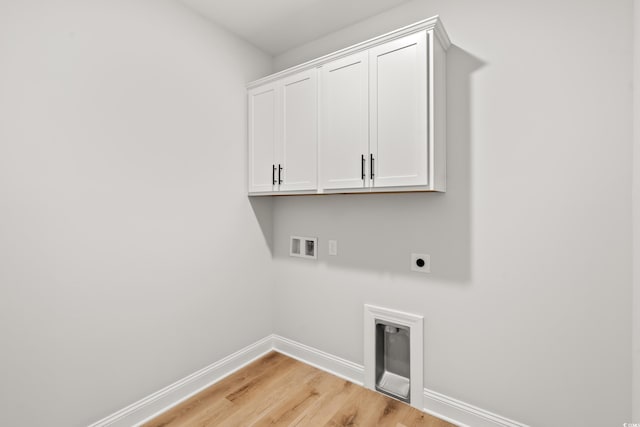 805 Comanders Island Rd, Georgetown, SC 29440 - washroom with electric dryer hookup, baseboards, hookup for a washing machine, light wood-type flooring, and cabinet space
