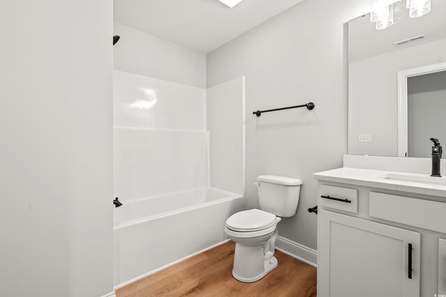 805 Comanders Island Rd, Georgetown, SC 29440 - bathroom featuring wood finished floors, vanity, toilet, baseboards, and bathtub / shower combination