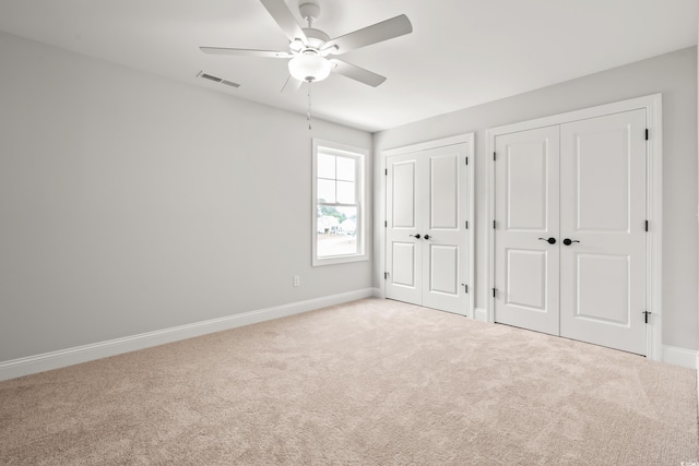 805 Comanders Island Rd, Georgetown, SC 29440 - unfurnished bedroom featuring multiple closets, carpet flooring, baseboards, and a ceiling fan