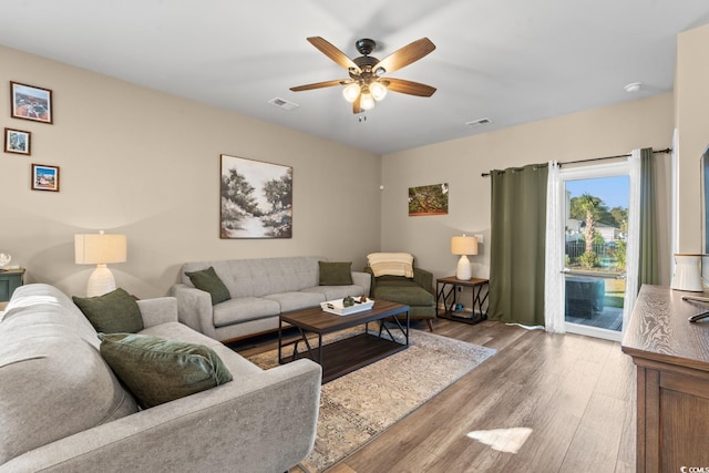 living room featuring ceiling fan and hardwood / wood-style flooring